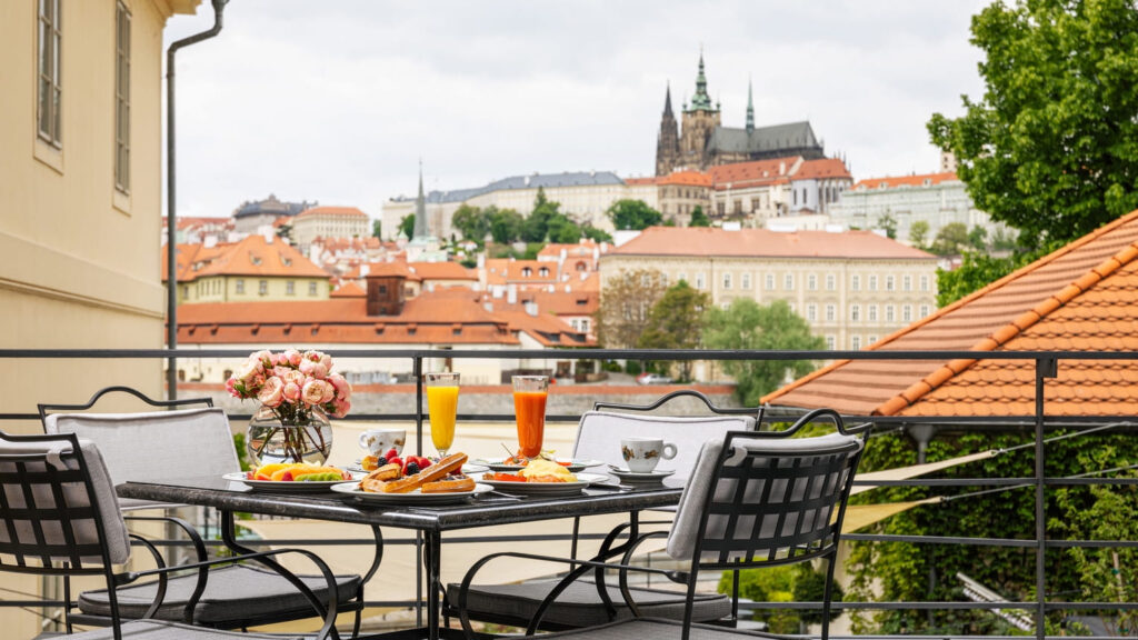 Breakfast with coffee and mimosas at Four Seasons Prague with a view over the Vltava River and Charles Bridge.